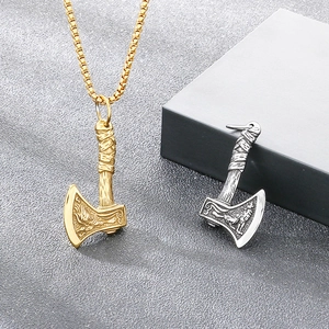 Close-up detail of vintage Viking battle axe pendant with intricate engravings