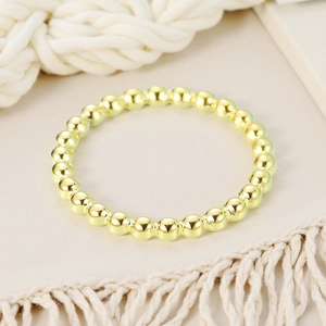 Detailed view of a minimalist 2mm golden stainless steel beaded ring for women stylishly displayed