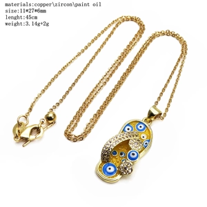 Copper flip-flop pendant necklace with cubic zirconia and blue evil eye enamel finish