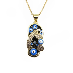 Macro view of crystal encrusted flip flop pendant with evil eye patterns on gold chain