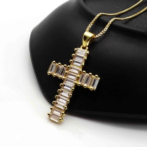 Detailed view of 14K gold plated cross pendant with rectangular cubic zirconia on snake chain