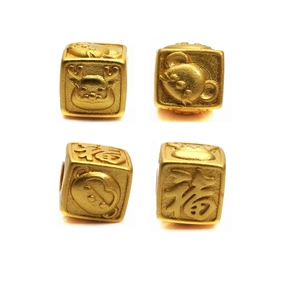 Macro shot of gold-plated zodiac beads featuring matte finish and lucky福 character