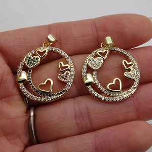 Golden heart-themed circular pendant with colorful zircon stones on hand display