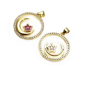 Macro detail of gold celestial star and moon charm with micro-set zircon crystals