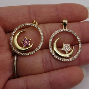 Micro paved zircon star and moon pendants in gold finish with pink and white gemstones