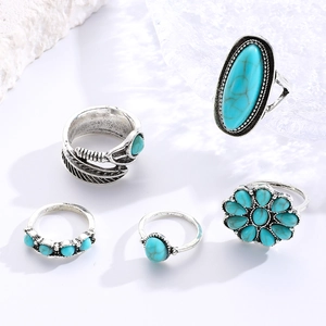 Detailed macro view of five vintage bohemian silver-toned turquoise rings set for women