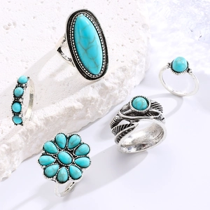 Detailed view of vintage Bohemian turquoise ring set with floral and leaf designs