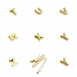 Close-up of 14K gold plated 3D alphabet charms for DIY jewelry making and necklaces