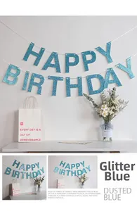 Detail of glitter dusted blue Happy Birthday banner with elegant lettering and white string