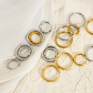 Detailed view of textured gold and silver hoop earrings in bamboo and mesh designs.