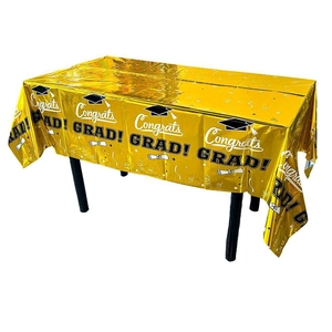 Close-up of metallic gold graduation tablecloth featuring Congrats Grad prints and caps