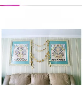 Detail view of metallic gold star banner garland hanging for party and home wall decor