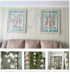 Close-up of white star bunting banners for party decoration hanging in a modern living room