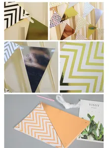 Detail view of metallic gold, silver and rose gold ripple triangle banners for party decor