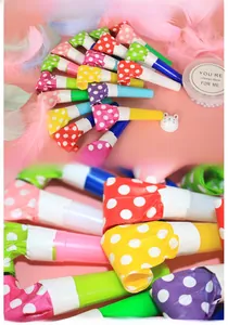 Macro detail of colorful polka dot party blowouts and festive whistles for celebrations