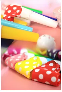 Detailed macro view of colorful polka dot party blowouts with plastic mouthpieces