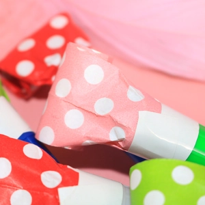 Colorful polka dot party blowouts for celebrations with plastic mouthpieces and paper tubes