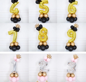 Detail of 32 inch gold and silver number balloons with crown toppers and latex base