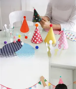 Detailed set of colorful polka dot cone party hats with pom-poms and shiny paper crowns