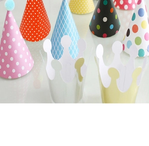 Close-up of colorful assorted party hats and paper crowns for children birthday decor