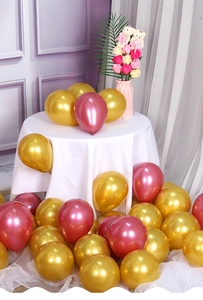 Detail view of shiny metallic gold and rose pink latex balloons for luxury party decoration