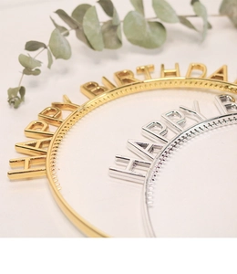 Detail of gold and silver Happy Birthday headbands with non-slip teeth and metallic finish