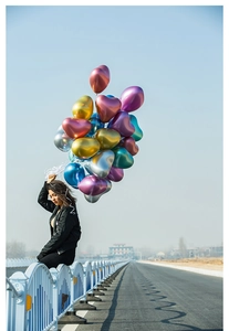 Macro view of metallic heart-shaped latex balloons in assorted colors for wedding decor