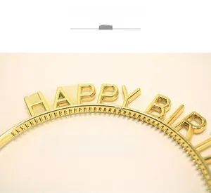 Macro detail of gold-plated Happy Birthday headband showing glossy metallic texture