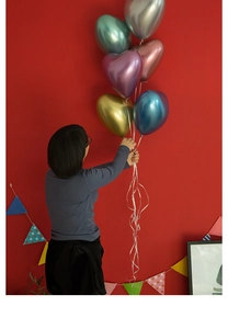 Detail of 10-inch heart-shaped chrome metallic latex balloons for romantic wedding decor