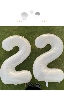Detail of 40-inch cream white number 2 foil balloons for birthday party outdoor setup