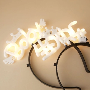 LED light-up birthday headbands featuring Baby text and crowns on a soft beige background