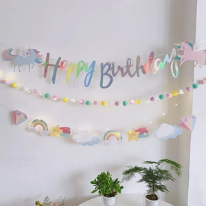 Unicorn Happy Birthday banner set with rainbow paper pendants and colorful pom pom lights