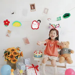 Detail of colorful Lucky Girl birthday banners with rainbow and cartoon charms