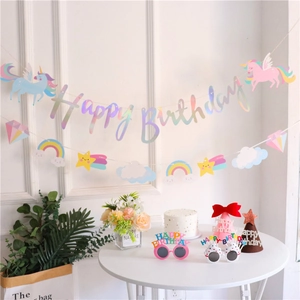 Iridescent Happy Birthday banner with unicorn, rainbow, and star cutouts for party decor