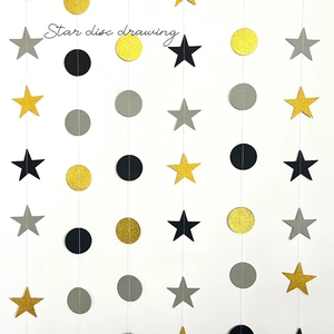 Detail of star and disc paper garland with glitter gold, black and grey hanging accents