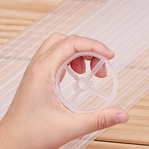 Close-up of clear plastic balloon stick holder with 4-rib cross support structure