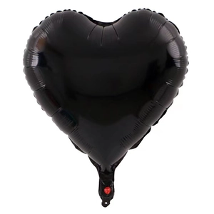 Detailed view of heart-shaped black foil balloon with metallic finish and inflation valve