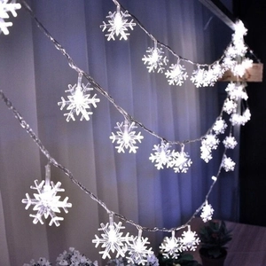 Cold white snowflake LED string lights for festive holiday window decor and wedding party