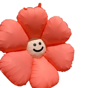 Coral orange daisy foil balloon with a minimalist smiley face for party decoration