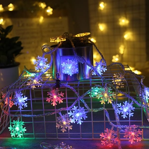 Close-up of snowflake LED fairy lights with colorful and warm white bulbs for decor