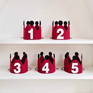 Five pieces of burgundy felt birthday crowns with white numbers 1-5 for baby party decor