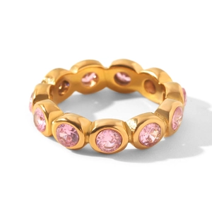 Close-up of gold-plated stainless steel ring with round pink cubic zirconia stones