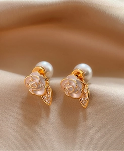 Close-up view of elegant camellia flower stud earrings featuring pearl and zircon detail