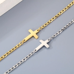 Close-up view of minimalist gold and silver stainless steel cross bracelets on a gray surface.