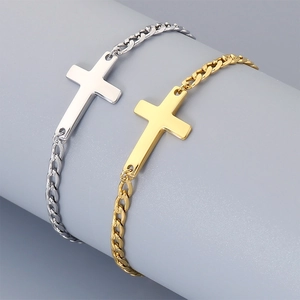 Detailed view of silver and gold stainless steel cross chain bracelets on a display.