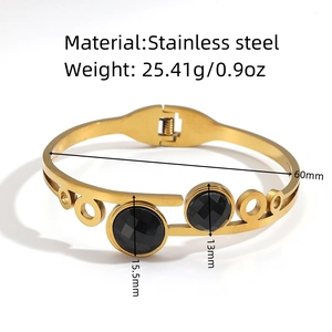 Detailed view of gold stainless steel bangle with black stones and dimensions