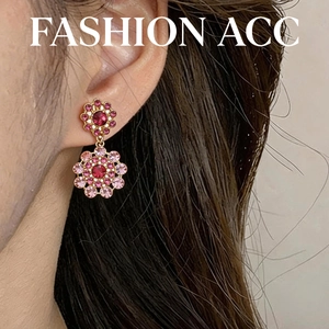 Elegant vintage gold hollow circular dangle earrings with pink crystals worn by a model