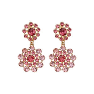 Elegant vintage palace style hollow drop earrings with pink rhinestones and gold plating.