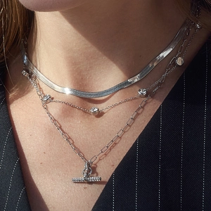 Detail of triple-layered silver-toned stainless steel necklace set with T-bar pendant