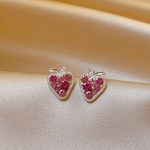 Sparkling pink and magenta zircon strawberry stud earrings on champagne silk background